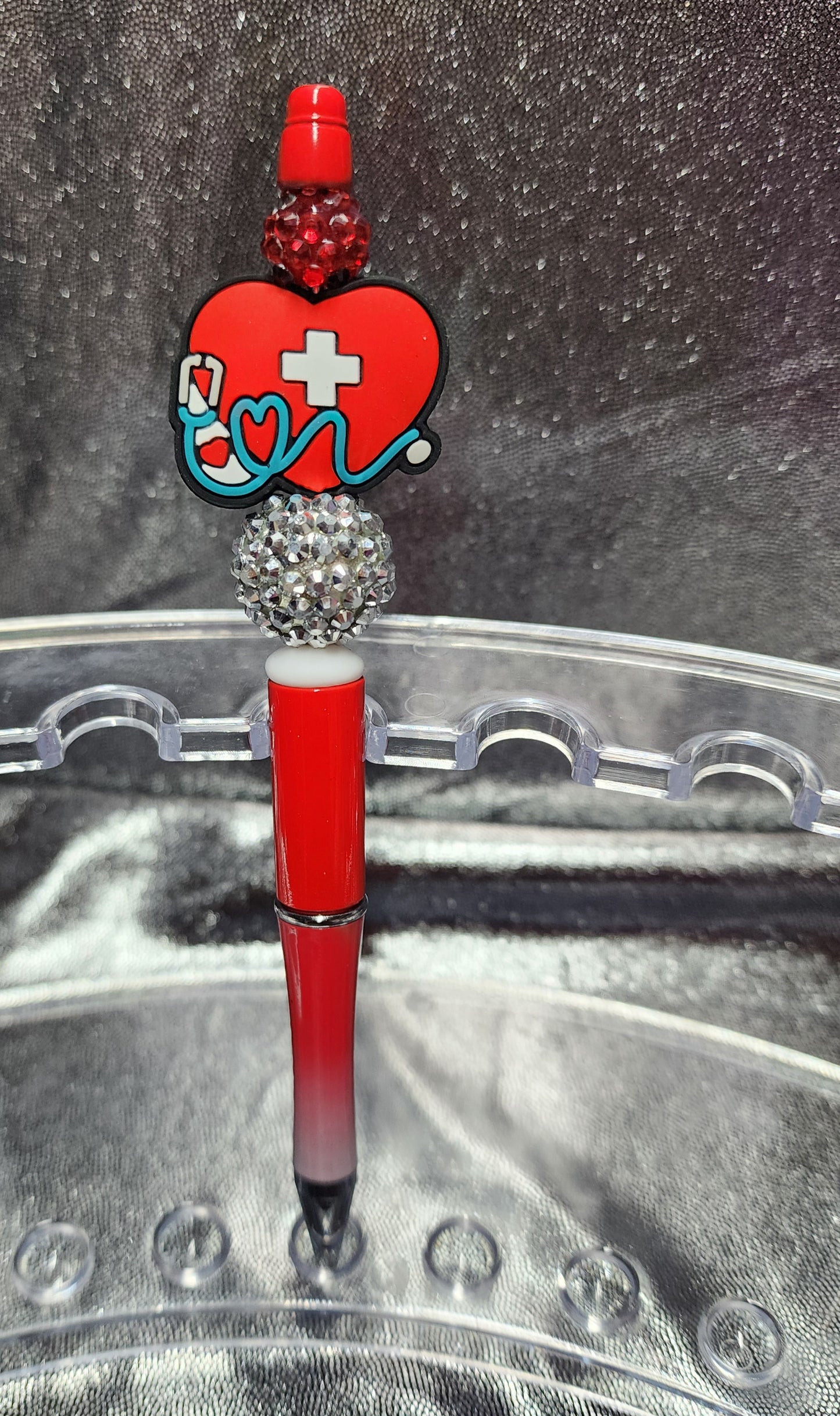 RED HEALTHCARE HEART WITH A STETHOSCOPE